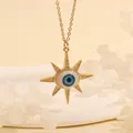 Detailed close-up of 18K gold evil eye pendant with sunburst design and zircon accents - Blue Star-B2