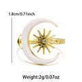 Detail shot of gold star and moon ring with white enamel and sparkling zircon inlay - Open Ring / White