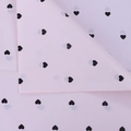 Close-up of pink tissue paper with black heart patterns for floral bouquet packaging - Pink Base Black Heart (28 Sheets/Pack)