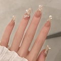 Close-up of elegant gradient press-on nails with white lines and delicate pearl accents - Z497 Pearl Silk / Nail Glue Version