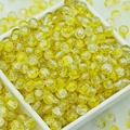 Close-up of yellow cracked glass beads for DIY jewelry making in a white container - 6mm / Lemon Yellow