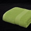 Folded grass green cotton bath towel with absorbent terry texture and woven edges - Gray-Bean Green