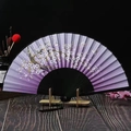 Macro detail of purple folding fan with cherry blossoms, butterflies and black silk tassel - Black Bone Purple Cherry Blossom