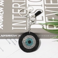 Funkelnder Evil Eye Schlüsselanhänger mit schwarzer Quaste und silbernem Karabiner - Schwarz
