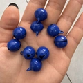 Set of eight 14mm blue painted metal bells held in palm for DIY pet collar accessories - Sapphire Blue