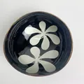 Coconut shell bowl with deep blue finish and large white floral patterns on inner wall - White Petal Style