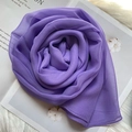 Detail of a deep purple silk scarf folded into a rose shape on soft white faux fur - Purple / 160x50cm