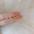 Detailed view of minimalist twisted triangle earrings in gold and silver finish - Mobius / Silver