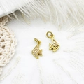 Macro shot of gold tropical fish charm with micro-paved white zircons on lace background - Fish