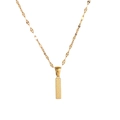 Macro detail of golden stainless steel necklace featuring a textured rectangular pendant - Letter I