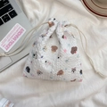 Close-up of cute cartoon dog pattern on a white seersucker drawstring storage bag - Star Dog