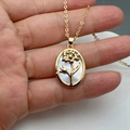 Macro shot of gold oval sunflower pendant necklace with white mother-of-pearl inlay - Style G