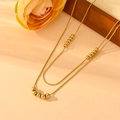 Detailed close-up of a double-layered gold titanium snake chain with polished bead accents - Gold Double Layered Necklace