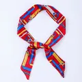 Red satin skinny scarf featuring vintage blue and yellow chain patterns in a classic layout - X31-Multi