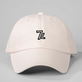 Detailed close-up of 7L logo embroidery on the front of a cotton twill baseball cap - One Size / Beige
