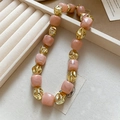 Detailed shot of pink marble resin beads and irregular gold metal beads on a bracelet - Pink Necklace