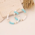 Detail of bohemian hoop earrings with blue heishi beads and pearls on stone base - Blue