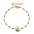 Detailed close-up of golden stainless steel bracelet with black beads and sailboat charm - Black Beads (SL1188-Black)