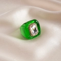 Close-up of vintage emerald green resin ring with large rectangular crystal on silk - Transparent Green