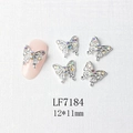 Macro view of silver butterfly nail charms with rainbow rhinestones on pink nails - Silver Micro-Pave Aurora Butterfly (7184)