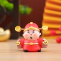Close-up of a cute God of Wealth figurine with gold coins and a basket of gold ingots - Wealth God - Full of Wealth