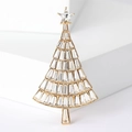 Macro shot of gold Christmas tree brooch with sparkling crystals on white background - Gold