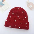 Detail of red cable-knit beanie with white pearls and metal beads on a white background - Wine Red
