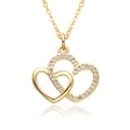 Close-up of interlocking gold heart pendant with sparkling white cubic zirconia pavé setting - White Zirconia Double Heart Layered Style (B067)