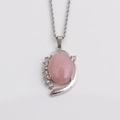 Macro detail of silver necklace with pink oval gemstone and sparkling crystal inlay - Pink