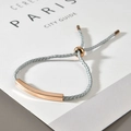 Close-up of adjustable grey woven rope bracelet with rose gold stainless steel tube bar - Grey Rope Rose Gold