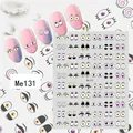 Macro detail of cartoon eye nail stickers showing diverse styles on pink nails - Me131