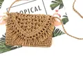 Close-up of handmade paper rope woven bag with long decorative fringe and straw texture - Tan