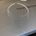 Close-up of a silver multi-layer layered chain necklace with detailed metal textures - Silver