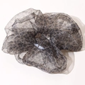 Detailed view of oversized leopard print scrunchie with semi-transparent shimmering fabric - Black Leopard
