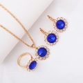 Golden jewelry set with round dark blue gemstones and sparkling crystal accents - Three-Piece Set / Round-Blue