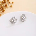 Detail view of silver textured earrings with liquid metal geometric wave design on white stand - Silver Fluid Irregular Geometric (E7117)