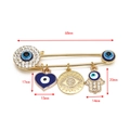 Detail of evil eye safety pin brooch with hamsa hand and heart charms, 68mm length - Gold Blue Heart - Hamsa Hand