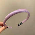 Detail of purple padded satin headband showing silky texture and handmade inner label - Purple