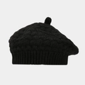 Close-up of black cable-knit wool beret with rib-knit edge and top pompom detail - Black