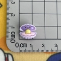 Miniature purple resin ocean shell charm with pearl measured on a centimeter scale mat - Shell