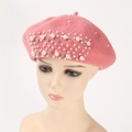 Close-up of pink cashmere beret featuring elegant hand-beaded pearls and rhinestones - Pink