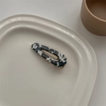 Macro shot of French vintage acetate hair clip with black and white marble patterns - Cow Pattern Water Drop