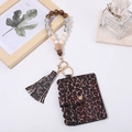 Close-up of leopard print card holder with wooden beads wristlet and tassel keychain - Leopard Print