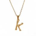 Detailed close-up of golden bamboo textured letter K pendant on a polished O-chain necklace - Letter K