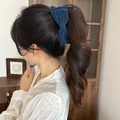 Detail view of a vintage navy blue velvet bow hair clip worn on model's head - Twist Clip / Blue