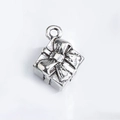 Macro shot of silver gift box charm with embossed ribbon texture for DIY jewelry making - Silver Gift Box