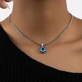 Close-up of model wearing evil eye pendant necklace with silver snake chain on black top - Silver Snake Chain Tri-color Round Evil Eye Pendant