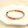 Detail of bohemian Tila bead bracelet with matte orange and pink beads on a shell plate - Orange Yellow Multicolor-H