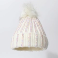 Close-up of white knit beanie with sparkling rhinestones and a fluffy faux fur pompom - White