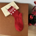 Red mid-calf socks with plaid ruffles and white floral embroidery on a wooden table - One Size / Plaid Flower